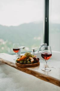 a plate of food and two glasses of wine on a counter at Dalina Bungalov in Ardeşen
