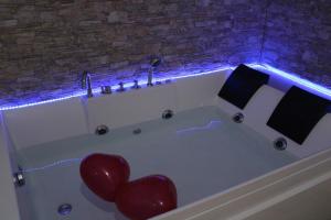 a bath tub with a red heart in it at Dolce Notte in Taranto