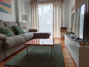 a living room with a couch and a coffee table at Apartamento Mar de Arousa in Ribeira