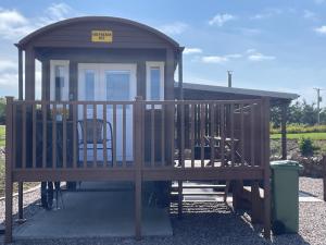 a gazebo with two chairs and a table at AC/DC Glamping in New Aberdour