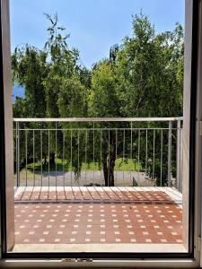 a view from a window of a porch with a fence at La Betulla in Arco