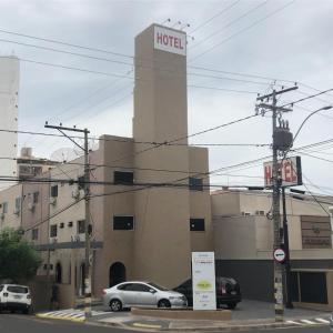 a hotel with cars parked in front of it at Hotel Redentora Plaza in Sao Jose do Rio Preto