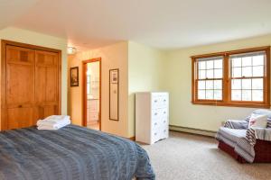 a bedroom with a bed and a dresser and a window at Great Location Outdoor Space Dog Friendly in Chatham