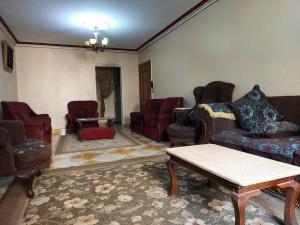a living room with couches and chairs and a table at Ramo City Stars Hotel in Cairo