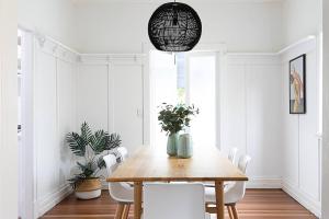 a dining room with a wooden table and chairs at Pet Friendly Family Home 3km to CBD in Brisbane