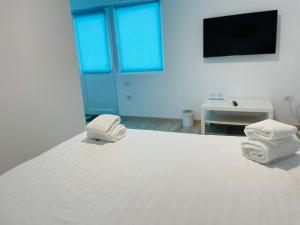 two towels sitting on top of a bed at Blue Sky Transalpina in Săsciori