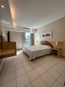 a bedroom with a bed and a television in it at Hotel Aliança Express in Rio do Sul