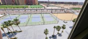 an aerial view of a tennis court with palm trees at جولف بورتو مشايه كود 27 in El Alamein