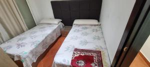 two beds in a small room with a sidx sidx sidx at جولف بورتو مشايه كود 27 in El Alamein