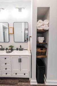a bathroom with a sink and a mirror at Cozy Cottage at the Springs in De Leon Springs