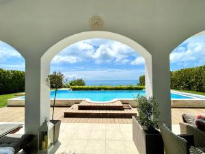 a view of a swimming pool from a house at Private seaview villa in BlackSeaRama - 1st line in Balchik