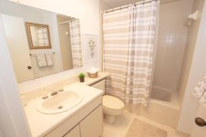 a bathroom with a sink and a toilet and a shower at Magnolias on Cobblestone in Wesley Chapel +42 photos