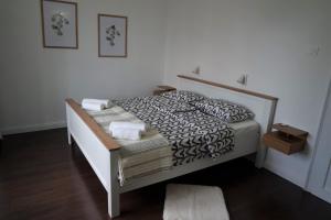 a bedroom with a bed with a wooden frame at Sea Flower apartment Rijeka in Rijeka