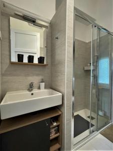 a bathroom with a sink and a shower at Sea Flower apartment Rijeka in Rijeka