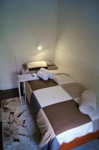 two beds in a small room with a table at Sea Flower apartment Rijeka in Rijeka