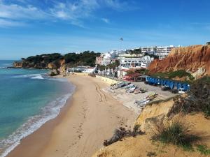 a view of a beach with buildings and the ocean at Maré Alta by CS in Olhos de Água