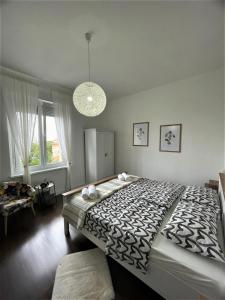 a bedroom with a large bed and a chandelier at Sea Flower apartment Rijeka in Rijeka