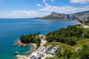 an aerial view of a resort on the shore of a lake at Luxury, seafront Villa IVAN with heated pool only 100m from beach in Omiš