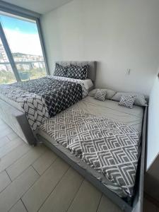 a large bed in a room with a large window at LovelyView Studio Edif 1 HeatedPool Gym Turco WIFI 1412 in Quito