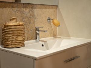 a bathroom sink with a basket on top of it at Pamp’Arles in Arles +63 photos