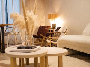 a living room with two tables and a couch at Pamp’Arles in Arles