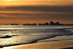 a view of the beach with a city in the background at Yacht Club Villas #1-202 condo in Myrtle Beach