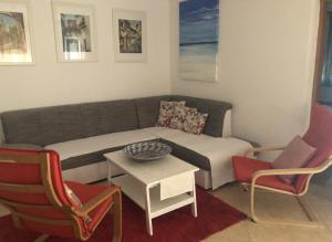 a living room with a couch and two chairs at Apartment F&M in Karigador