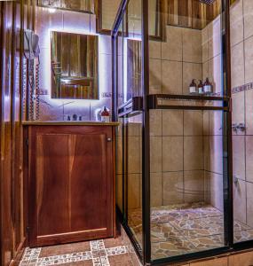 a shower with a glass door in a bathroom at Cabañas Hoja Verde in Monteverde Costa Rica