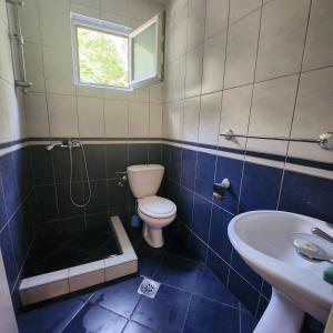 a bathroom with a toilet and a shower and a sink at A step to the sea-Na korak do mora-Studio apartments Bela kuća in Rafailovici