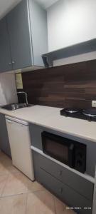 a kitchen with a sink and a counter top at olivegrove in Sidari