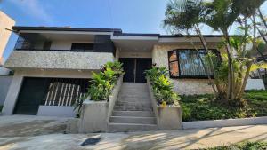 a house with stairs leading to the front door at Las Lomas Luxury House2 in Medellín
