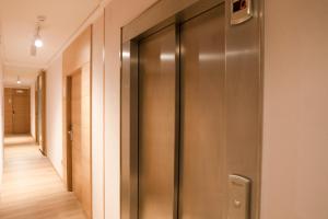 a hallway with a metal elevator in a building at Hotel Caribe Sanxenxo in Sanxenxo