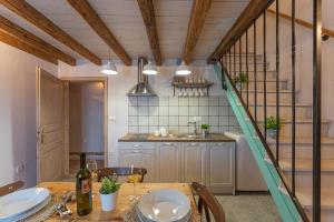 a kitchen with a wooden table and a staircase at Johan i Matija in Grandići +49 photos