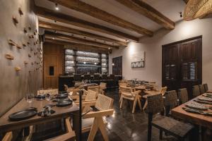 a dining room with wooden tables and chairs at Hotel Sutuk in Valladolid