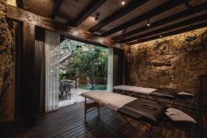 a room with a bed and a large window at Hotel Sutuk in Valladolid