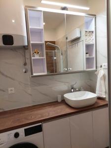 a bathroom with a sink and a mirror at Apartment Antea in Split