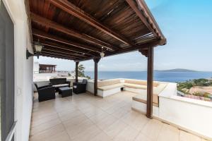 an outdoor patio with a view of the ocean at Sea View Duplex Private Villa in Bodrum Gundogan in Gundogan