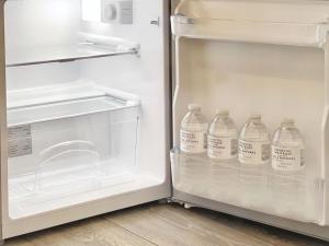 a refrigerator with several bottles of water in it at Erin Court Mansions - Suite 10 in Croydon
