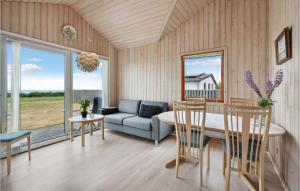 a living room with a couch and a table and chairs at Gorgeous Home In Esbjerg V With House Sea View in Esbjerg