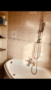 a shower in a bathroom with a bath tub at Ac lounge36 Room B in Rochford +17 photos