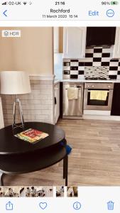 a kitchen with a black table and a stove at Ac lounge36 Room B in Rochford