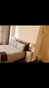 a small bedroom with a bed and a night stand at Ac lounge36 (B) in Rochford