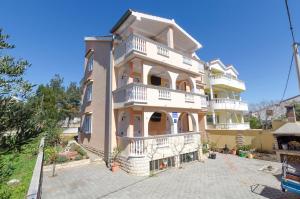 a large building with balconies on the side of it at Apartments Vladimir in Vodice