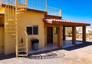 a house with a staircase in front of it at Casa Sunrise - El Dorado Ranch Vacation Rental Home in San Felipe