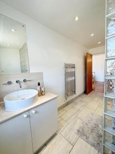 a bathroom with a sink and a mirror at The London Loftscape in London
