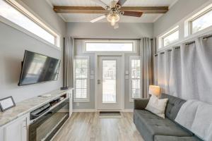 a living room with a couch and a tv at Austin Tiny Home with Community Pool and Hot Tub! in Austin