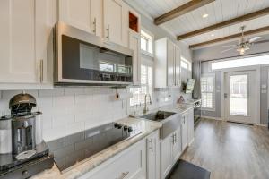 a kitchen with white cabinets and a sink at Austin Tiny Home with Community Pool and Hot Tub! in Austin