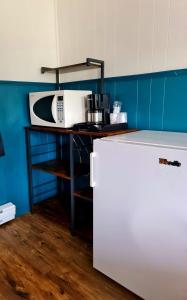 W kuchni znajduje się biała kuchenka mikrofalowa i lodówka. w obiekcie The Voy w mieście Schreiber