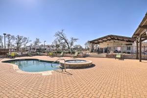 a swimming pool in a park with a pavilion at Austin Tiny Home with Community Pool and Hot Tub! in Austin