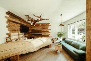 a bedroom with a large bed and a couch at OM Resort in Gura Teghii